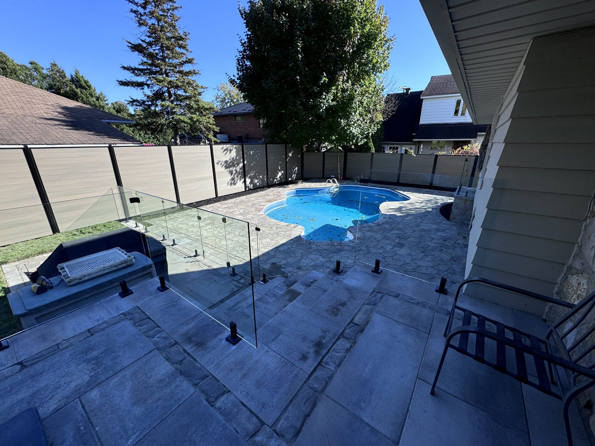Glass railing with cap rail on outdoor deck