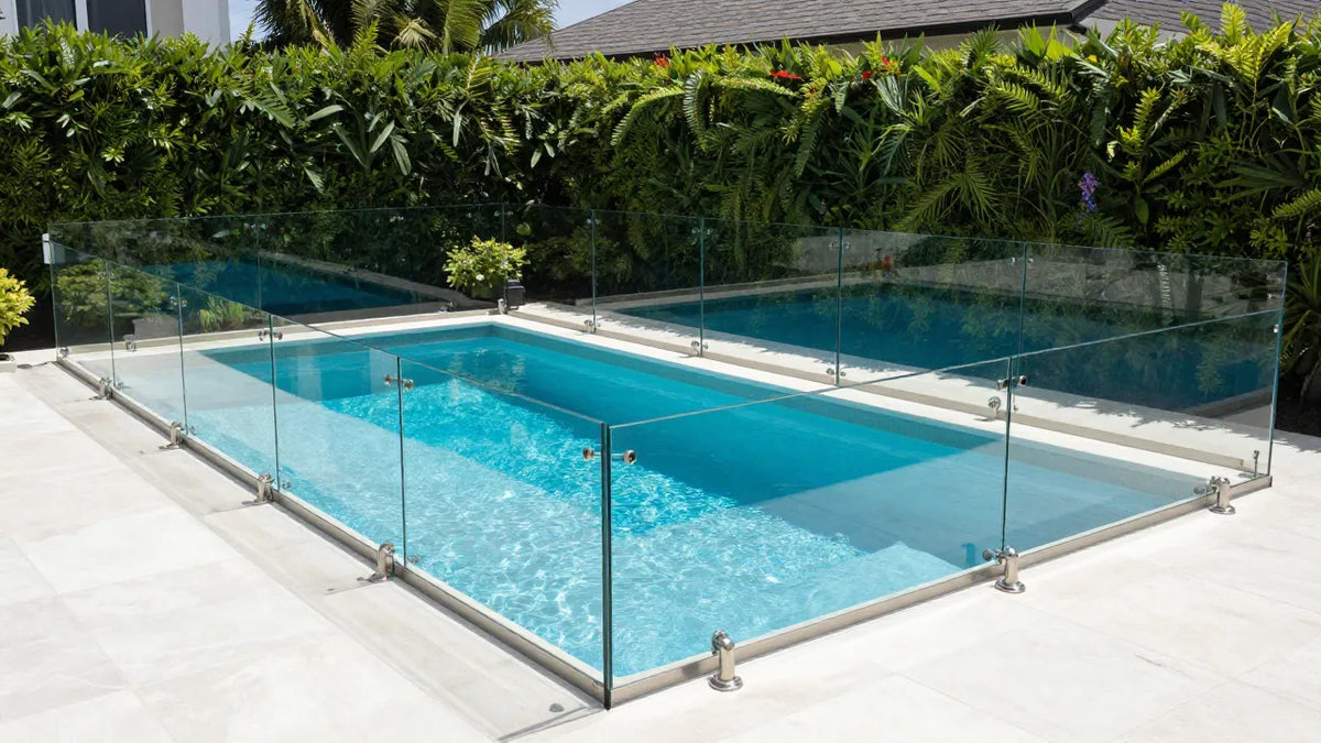 Glass railing around pool in Texas residential backyard