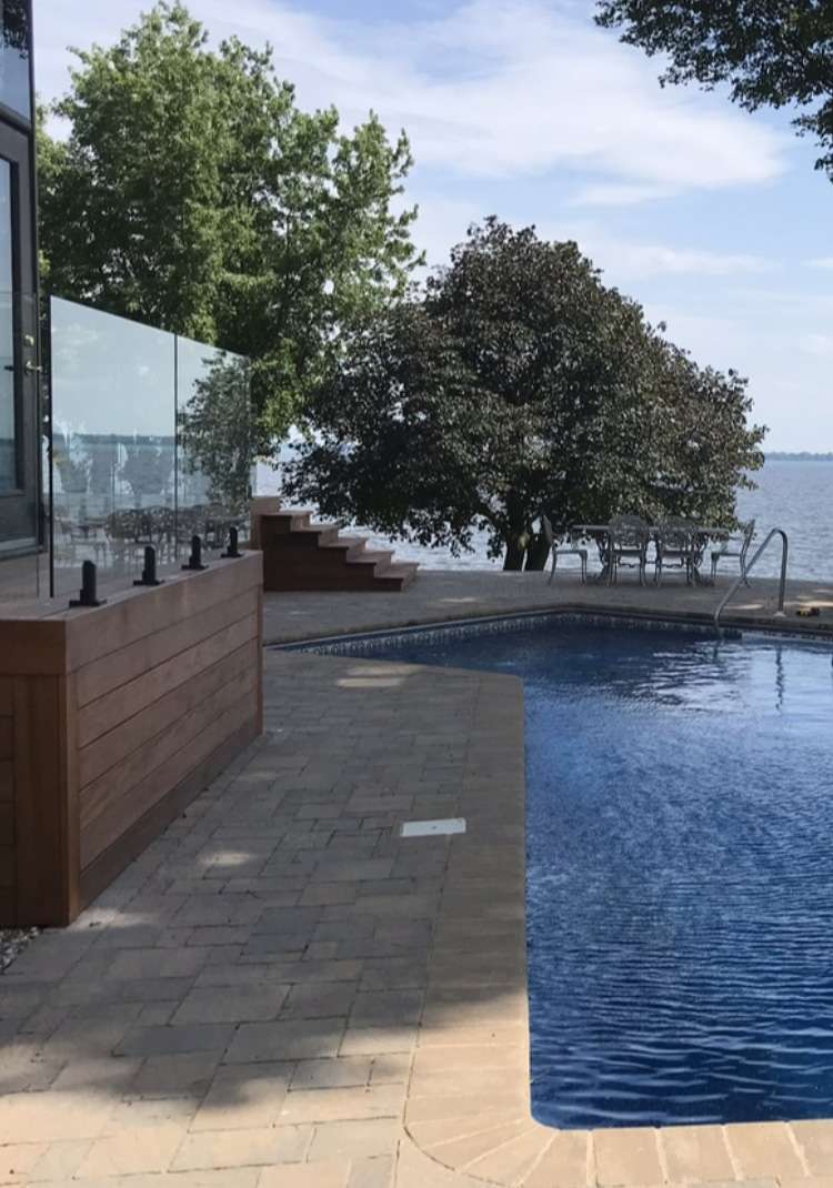Glass fence around pool with waterfront view